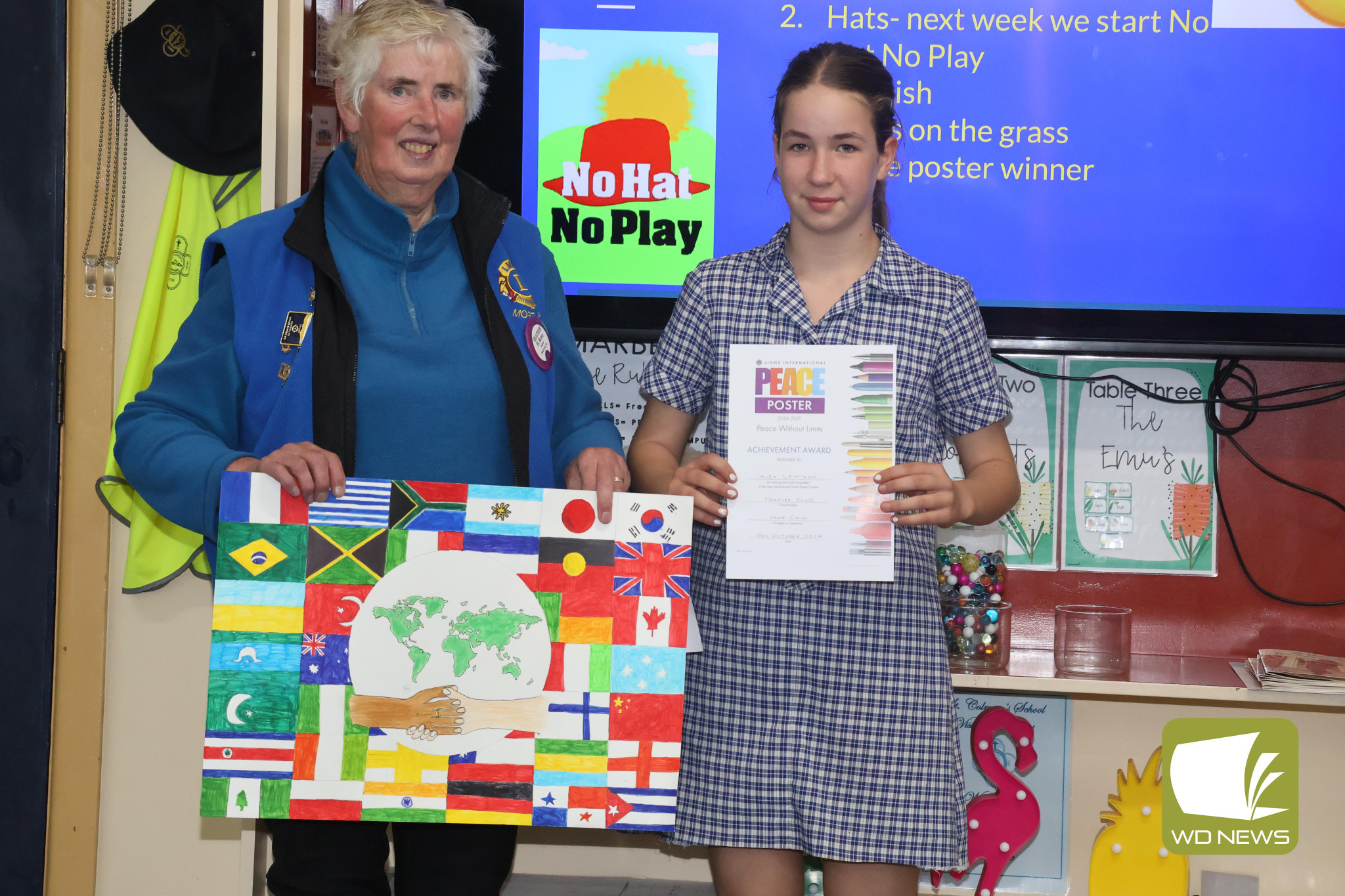 Peace: Mortlake Lions Club president Heather Rowe with St Colman’s Primary School peace poster winner Alex Lehman.