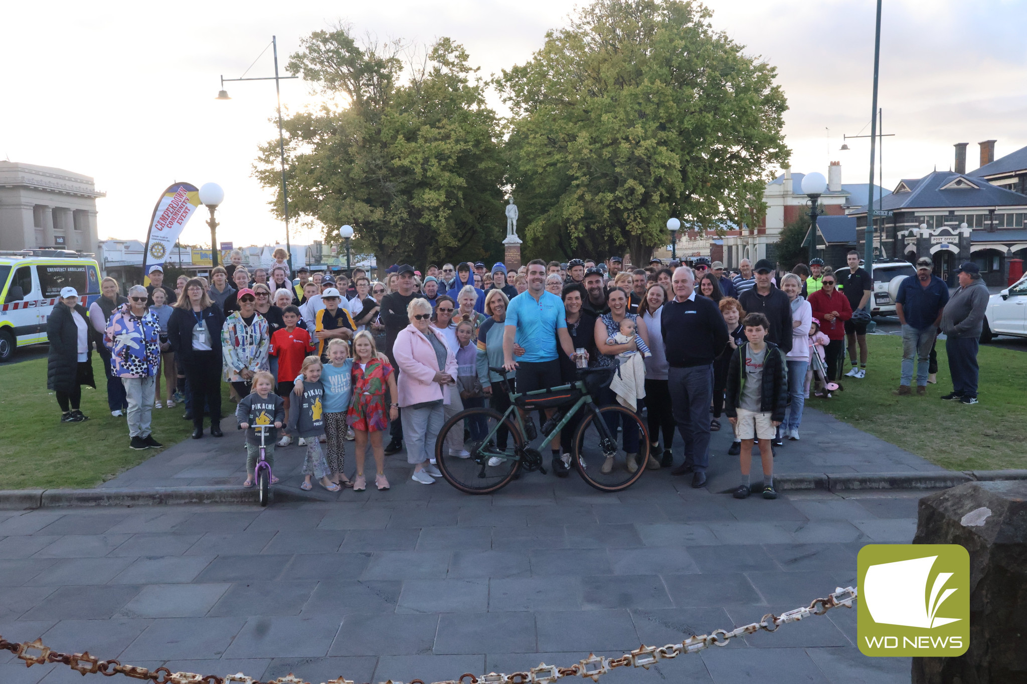Welcome home: Residents gathered around the Camperdown Clocktower to welcome Jake Rowbottom back to his hometown as he completed his bike ride on Friday.