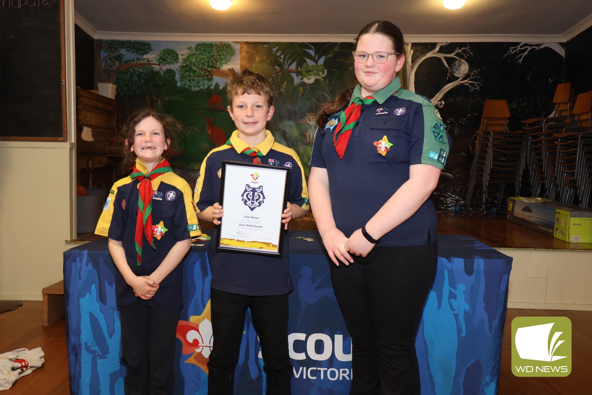 Congratulations: Cub Scout Liam Rowe (middle) celebrated earning a Grey Wolf Award, the peak award for a Cub Scout, last week with his sisters Lucy and Amelia.