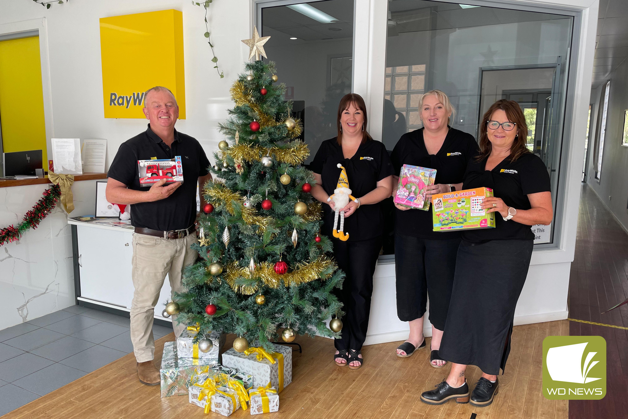 Christmas spirit: Ray White Rural Timboon staff are encouraging the community to donate a gift for families in need to this year’s Little Ray of Giving Appeal.