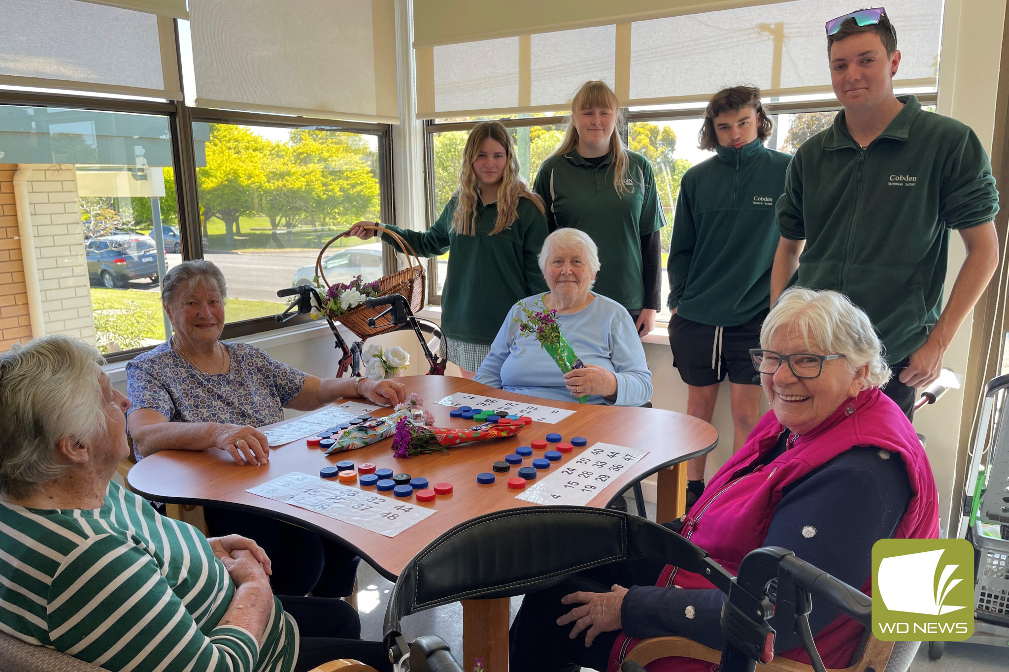 Community spirit: Cobden Technical School VCE VM Year 11 students spent time this term getting to know residents at Codenhealth - on their last visit for the year they handed out bouquets of flowers and chocolates to residents.