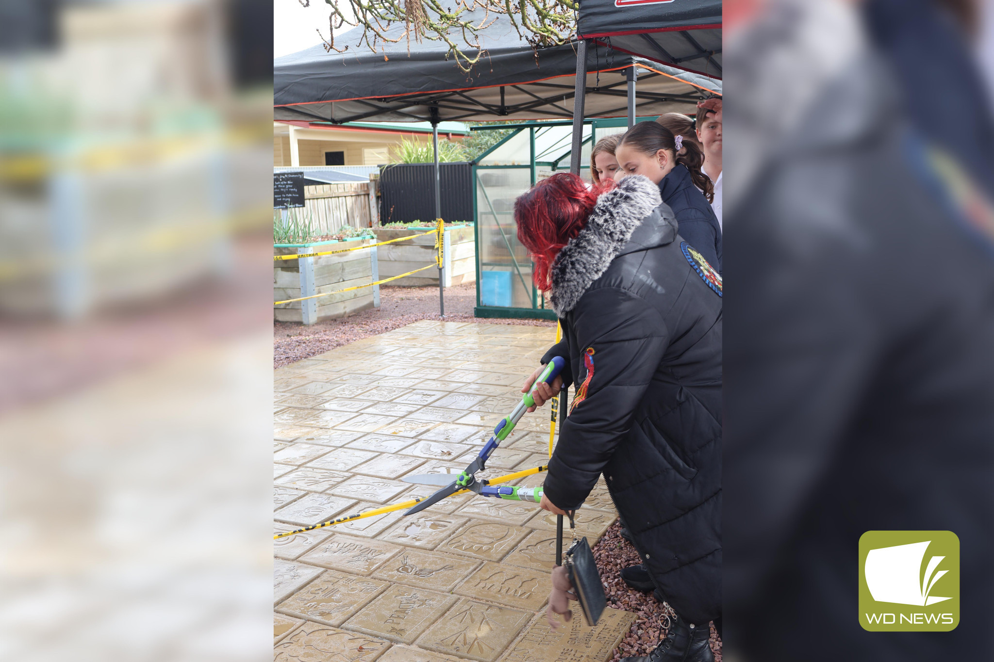 Unveiling: Artist Michelle Shearer cut the tape to unveil the new pavers, which were decorated as part of a community art project.