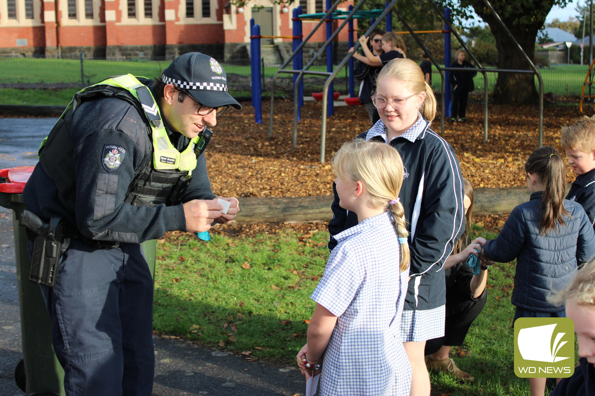 Camperdown Police’s Sam Alexander helps explain the importance of road safety at Camperdown College’s Walk Safely to School Day.