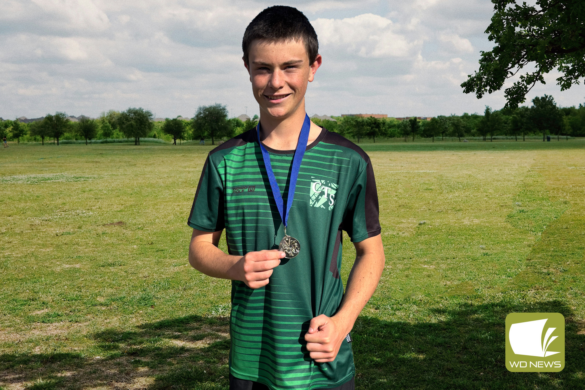 Riley Beames with his age group champion medallion.