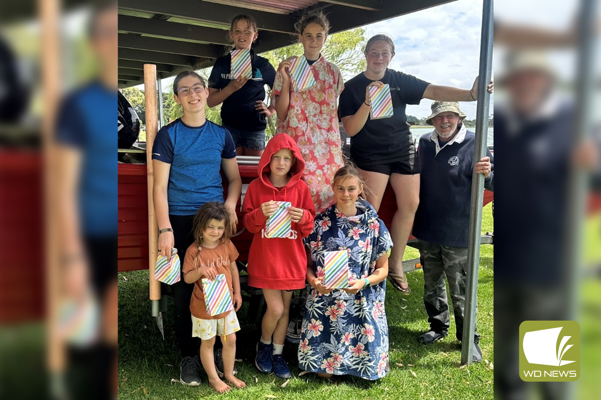 The learn to sail crew: Aenid Wood, Elise Wood, Lilley Melano, Jayde Melano, Mikayla Melano, Felicity Wood and Natalie Dwyer with commodore Phil Noone.