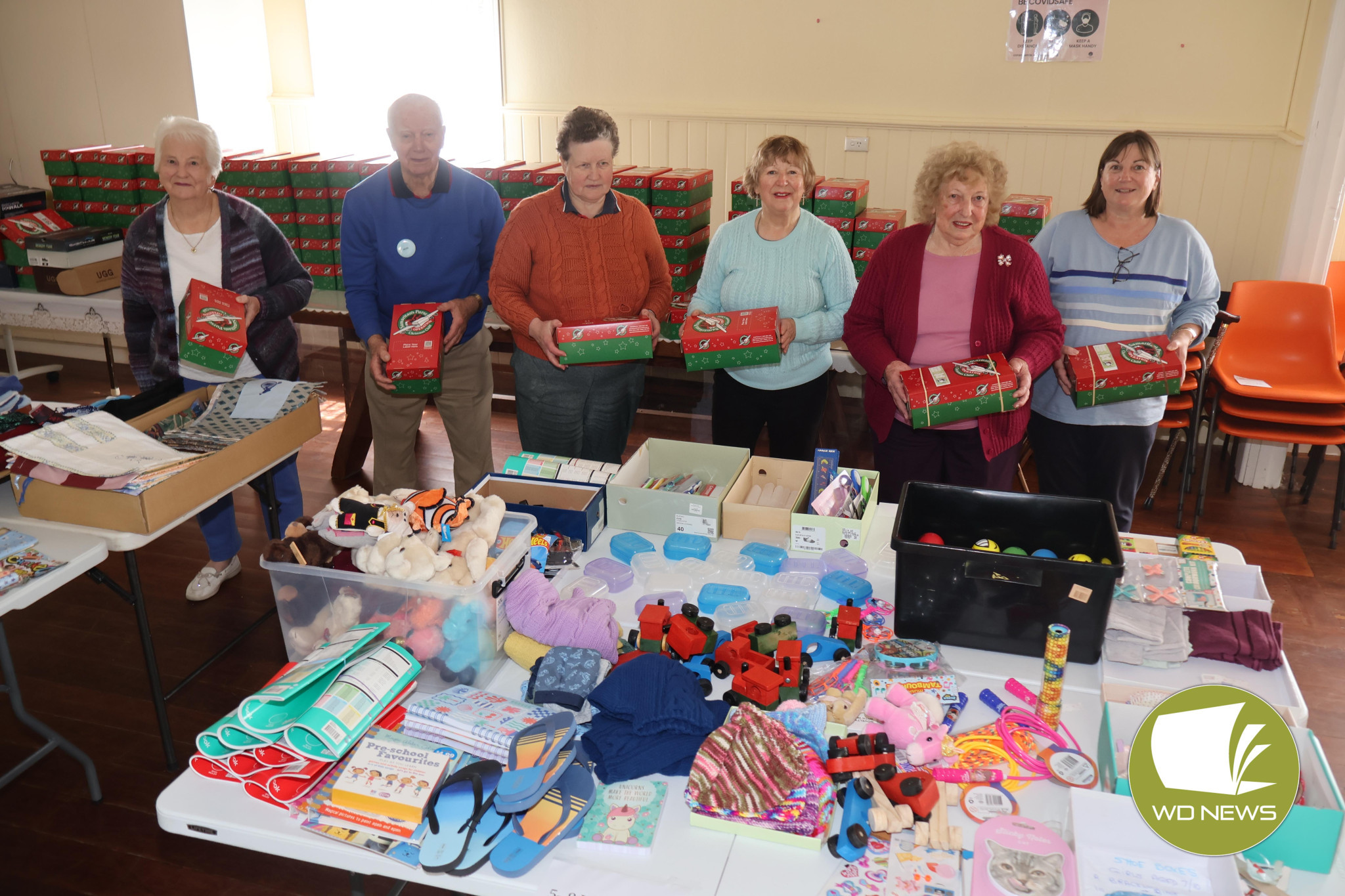 Generosity: Volunteers gathered over the weekend to pack 135 boxes with Christmas presents to be delivered to those who need them most this Christmas.