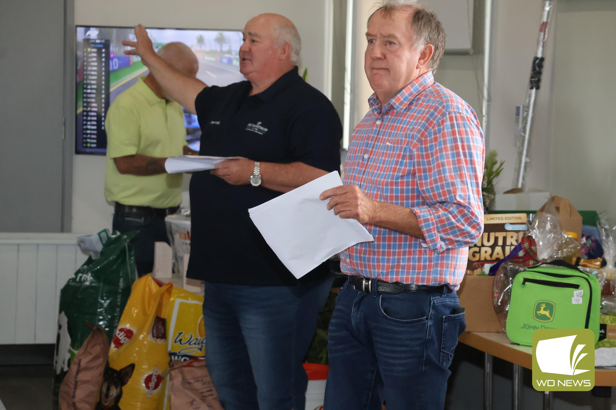 Funds raised: The community dug deep this year as part of the Good Friday Appeal, including Garvoc smashing its own fundraising record by more than $9000. Pictured is Jack Kelly and Tim Healy taking bids at the Garvoc goods and services auction.