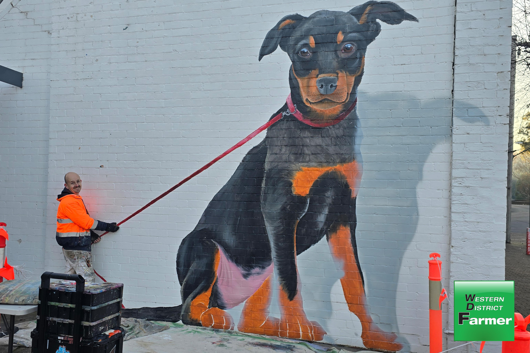 Warrnambool-based artist, Jimmi Buscombe, is delighted with his latest interactive work - a sweet kelpie bitch, adorning the west wall of Casterton’s Glenelg Inn.