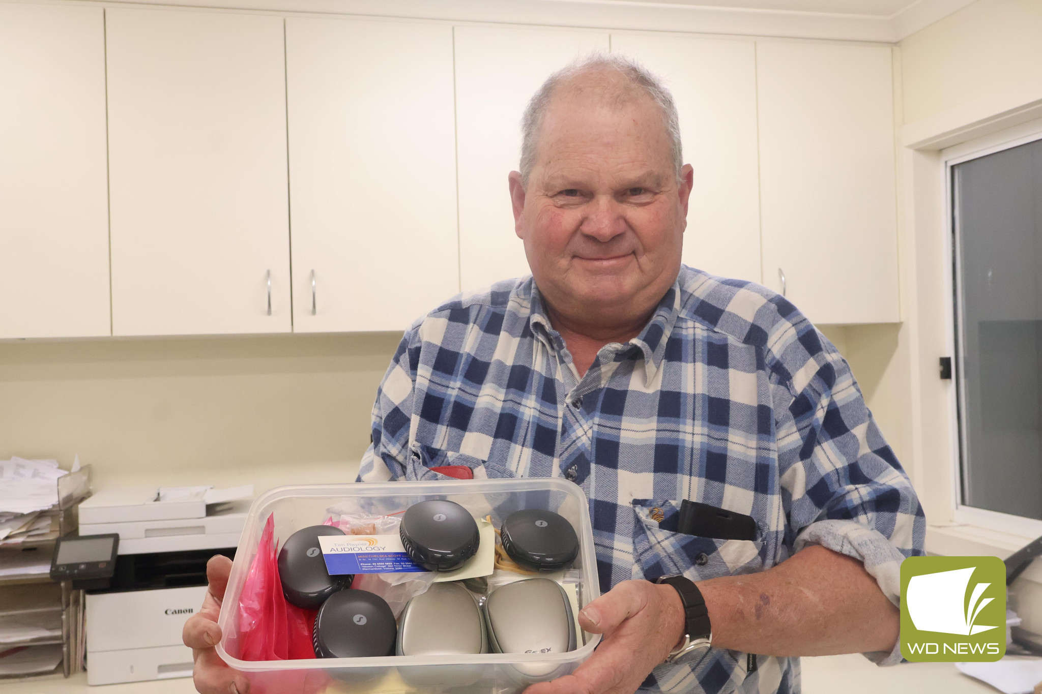 A kind gift: Future Freight’s Peter Matthews showing off some of the 450 hearing aids donated to Michelle Smith’s aid campaign.