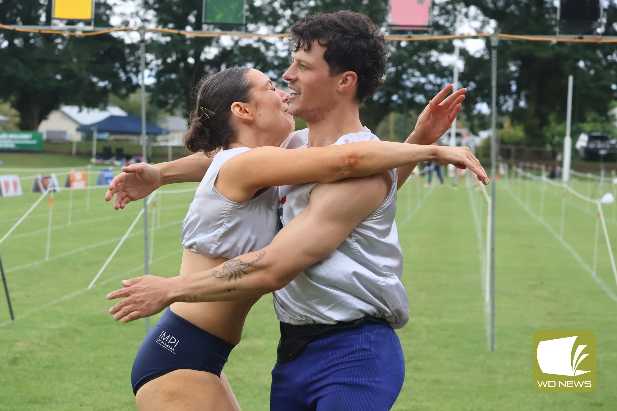 120 metre men and women’s winners Imogen Nobbs and John Evans celebrate their respective victories.