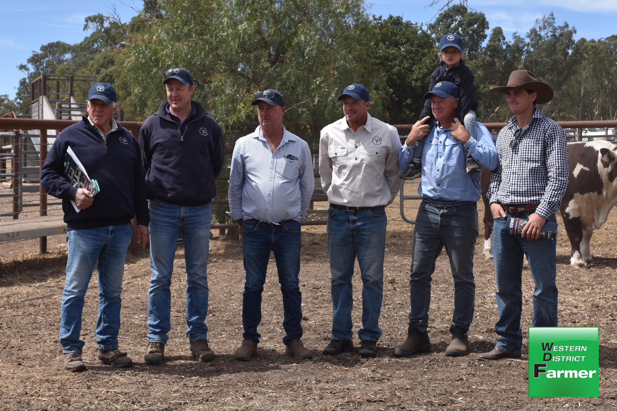 February 16 saw the end of an era at Yarram Park with the last Hereford Bull sale, ending a proud 75 year-tradition. Pictured from left are Yarram principal Ant Ballieau, manager Crai Brewin, cattle manager Mick Petersen, Ruki Ballieau, Sam Ballieau and (on shoulders) young Archie Ballieau with a purchaser (right).