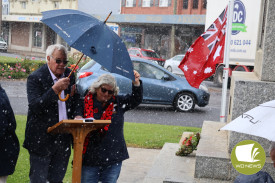 Terang Returned and Services League sub-branch vice president Terry Fidge and president Dianne Meade braced as hail fell during the service.
