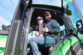 Chris Haberfield and son Max (3) take a close look inside one of the tractors on display.